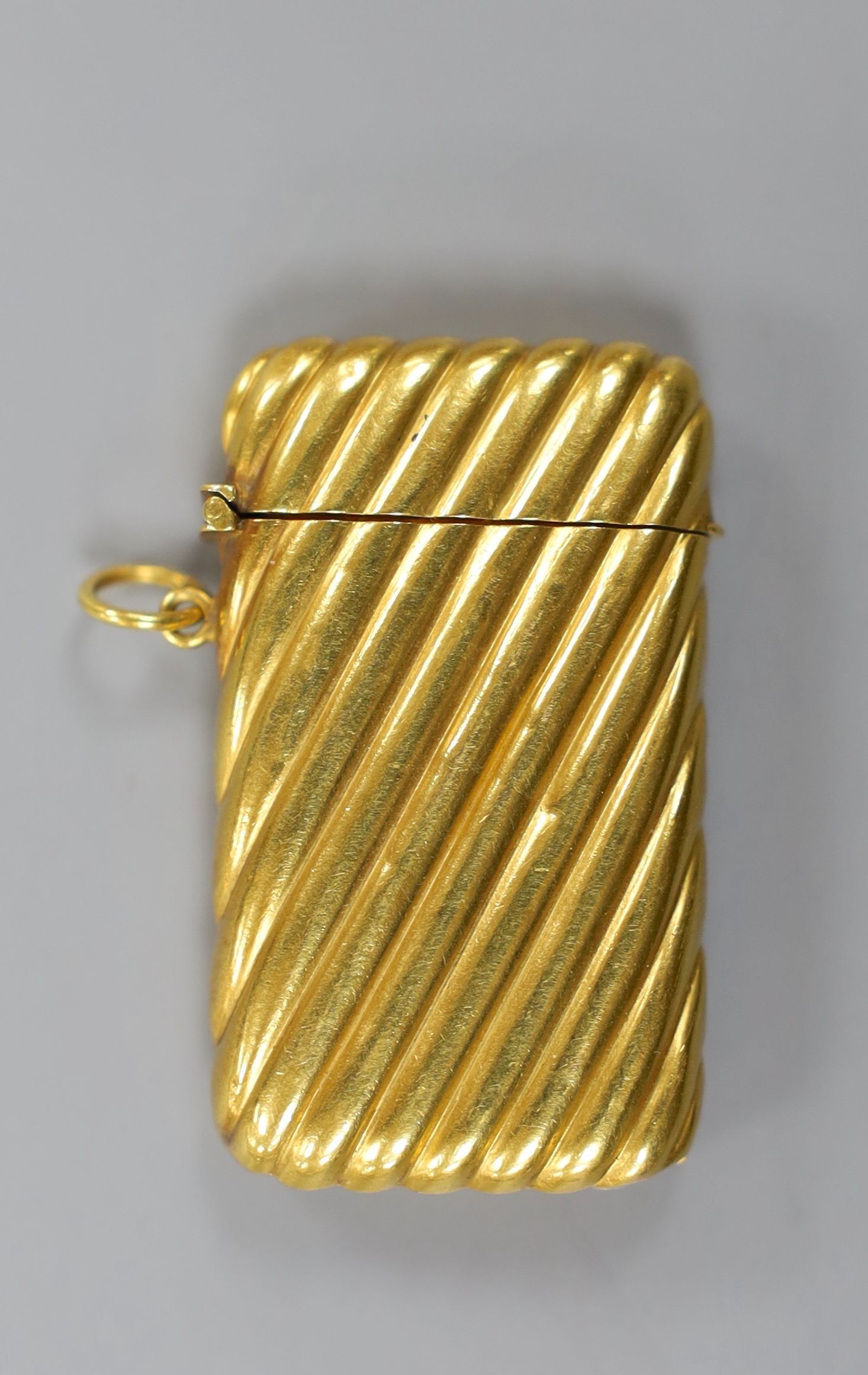 An early 20th century French fluted yellow metal (18ct poincon mark) vesta case, 45mm,gross 13.5 grams.